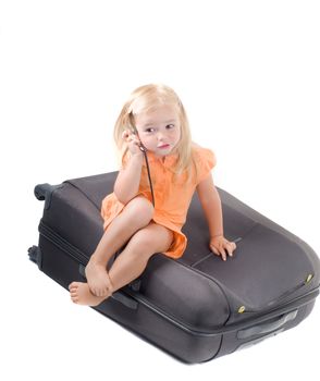 Shot of little girl and suitcase in studio