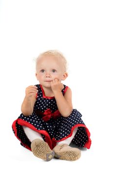 Shot of little girl in polka dot dress in studio