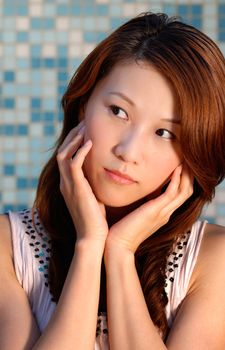 Modern asian beauty portrait with close-up thinking expression.