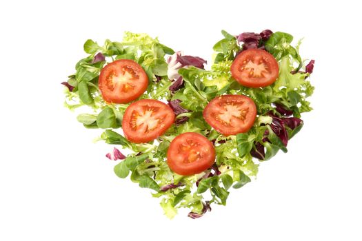 A heart of tomatoes and green salada suggesting the ideas of love and healthy nutrition.