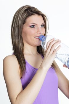 beautiful blond woman drinking water after sport