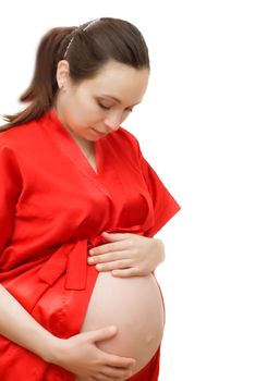 Pregnant female looking on her belly on white background