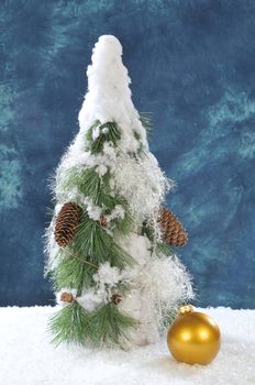 Decorative stylish christmas tree on snow