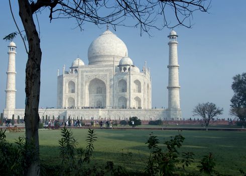 Massive white monument with minarets between green and blue.