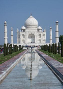 Massive monument with four minarets against blue sky.