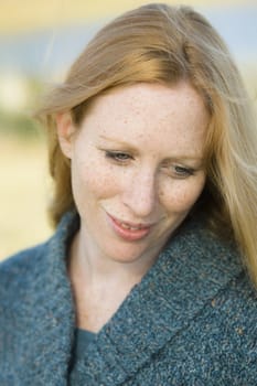 Portrait of a Pretty Redhead Woman Outdoors