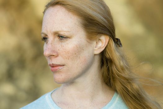 Portrait of a Pretty Redhead Woman Outdoors