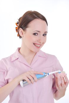 pretty girl with dentures and electric toothbrush