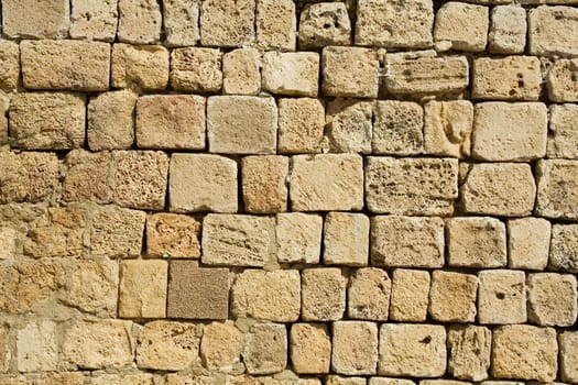 Wall constructed of stone bricks. A fine textural background for graphic design