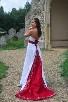 bride outside in red and white dress