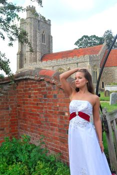 bride in white dress outside church