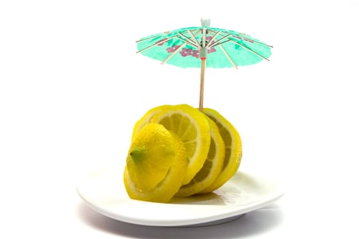 Yellow juicy lemon on a white plate on a white background