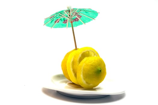 Yellow juicy lemon on a white plate on a white background