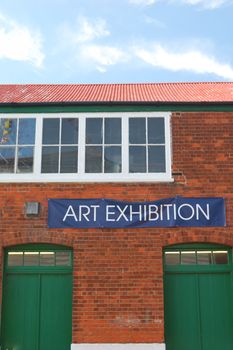 Art exhibition sign with brick building