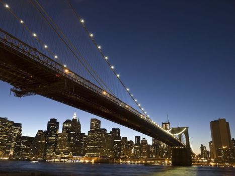 View of the Brooklyn bridge and south Manhattan from Brooklyn at dusk.