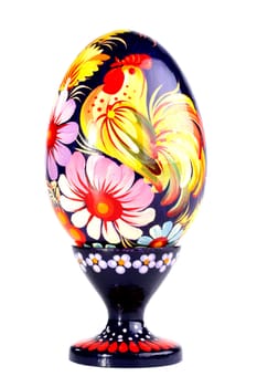 Wooden painted egg in style of Russian varnish list on a support. On egg flowers and a cock a symbol of the Russian village are drawn.