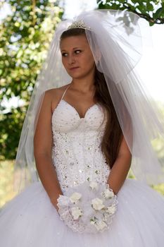 The bride with a bouquet of white flowers