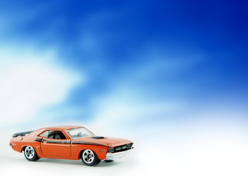 Dodge Challenger replica car on cloud background.