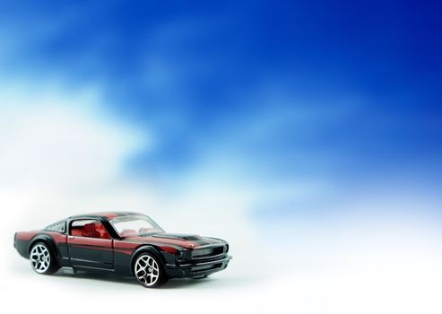 Ford Mustang replica car on cloud background.