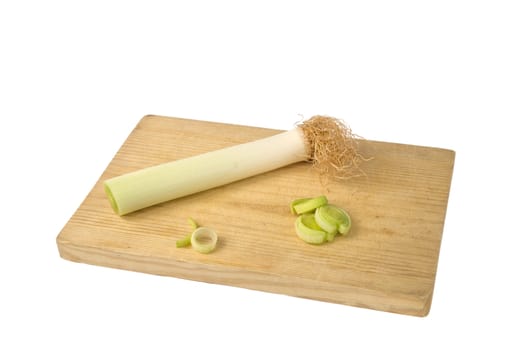 Leek on chopping board isolated over white.