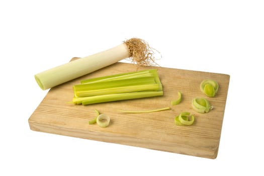 Cut fresh leek over a wooden chopping board.