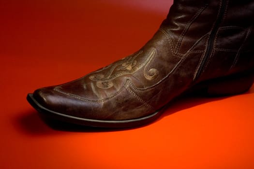 The ornate man's boot  on a red background