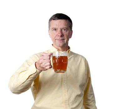 Senior male holding a pint of brown ale in english style mug and raising the drink in a greeting