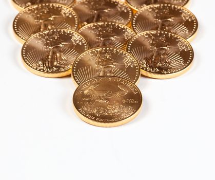 Golden Eagle coins forming a receding stack into the background