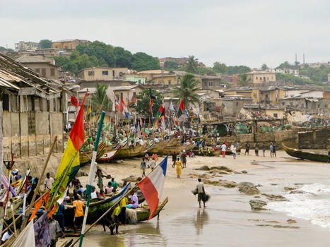 Fishermen and colorful boats on beach near Accra in Ghana in West Africa