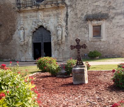 View of the garden and cross in front of the Mission Espada near San Antonio in Texas