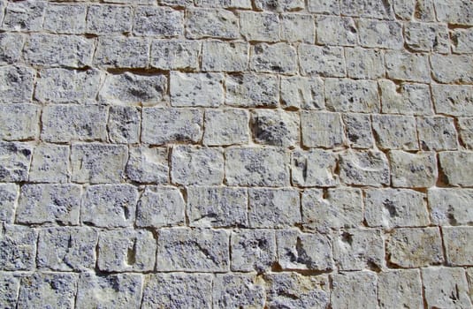 Detail and texture of medieval buildings. Limestone wall in Malta.