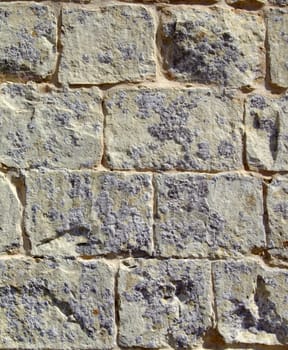 Detail and texture of medieval buildings. Limestone wall in Malta.