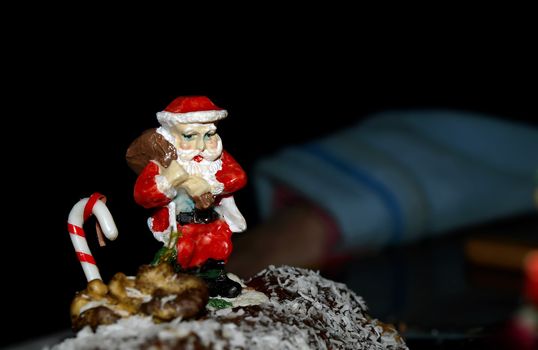 Christmas cake with chocolate and coconut and nut dressing with ornaments