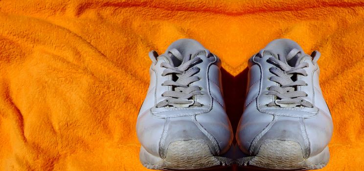 Detail shot of old worn out sneakers, depicting the sneaker culture