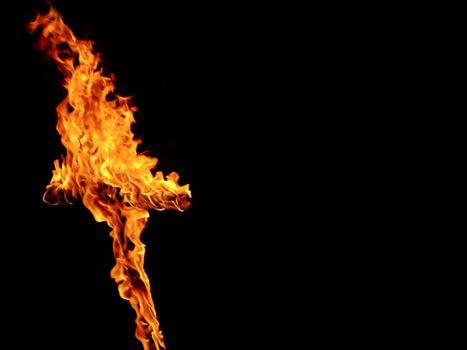 Burning crosses being used as part of ritual, on black background