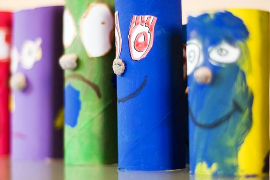 colored cylinder shaped puppets standing