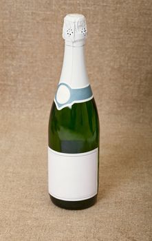 One bottle of sparkling wine against a drapery