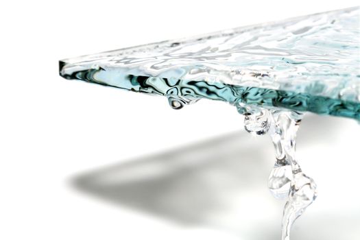 Abstract composition with glass and flowing water on white background