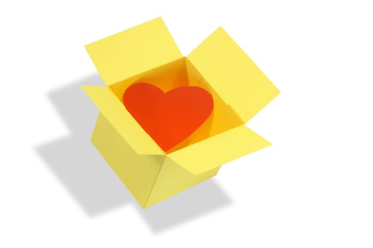 Red paper heart inside yellow open box. Isolated on white background with clipping path