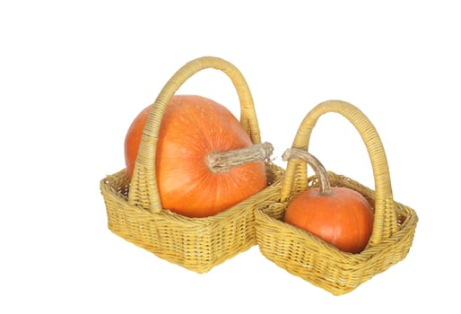 Two yellow wicker baskets with pumpkins isolated on white with clipping path