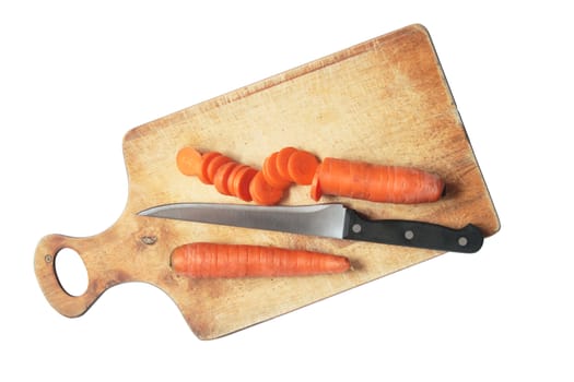 Sliced carrots and kitchen knife lying on breadboard. Isolated with clipping path