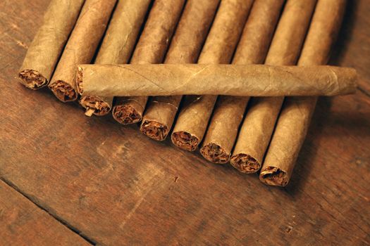 Closeup of cigar's row on wooden background