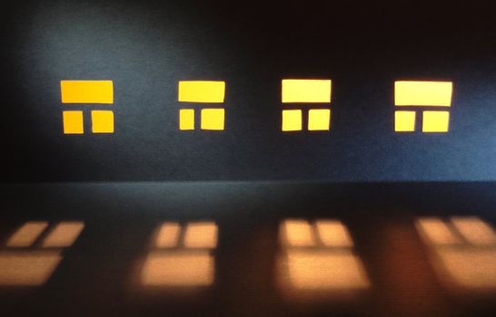 Abstract background made from paper: wall of house with luminous windows