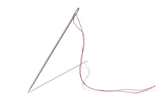 Closeup of sewing needle and red thread standing on white background. Isolated with clipping path