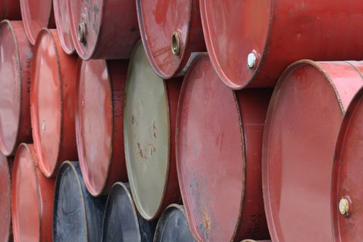 Industry background with row of holding colored tanks in an oil factory