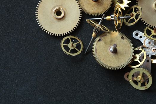 Old assorted gearwheels isolated on dark background with copy space
