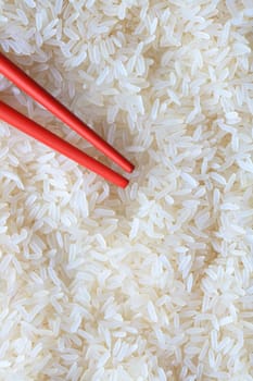 Red chopsticks lying on high quality long rice background