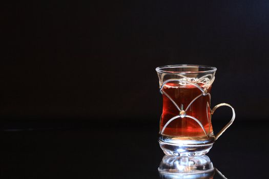 Nice cup of black tea isolated on dark with copy space