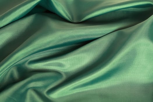 Background made from nice smooth green textile