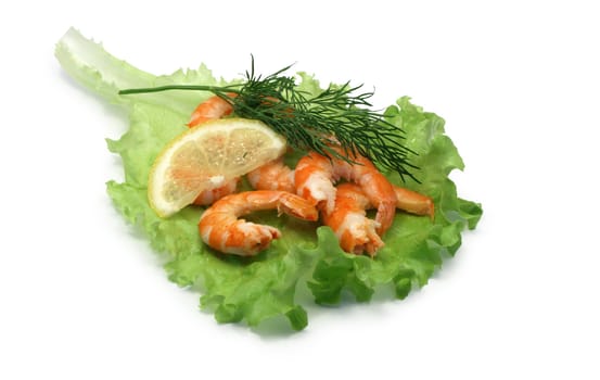 Cooked shrimps, lemon and greens lying on green leaf of lettuce. Isolated on white with clipping path